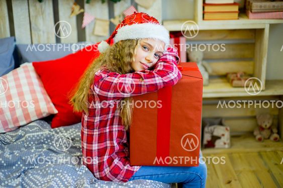 happy child girl with Christmas gifts
