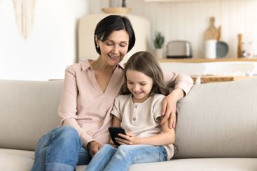 Little granddaughter share photos on cell screen with...