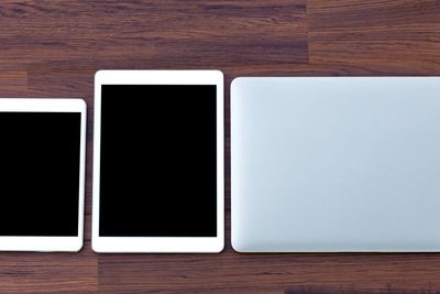 laptop with tablet and smart phone on table