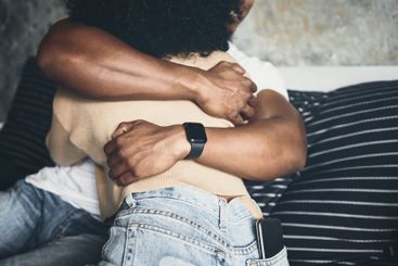 Closeup, couple and hugging in home for support with...