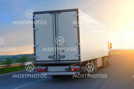 truck moves on highway at sunrise