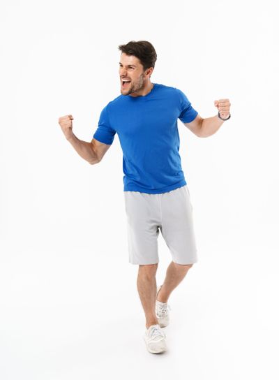 Full length photo of joyful man in shorts and t-shirt...