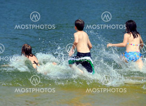Children running into water