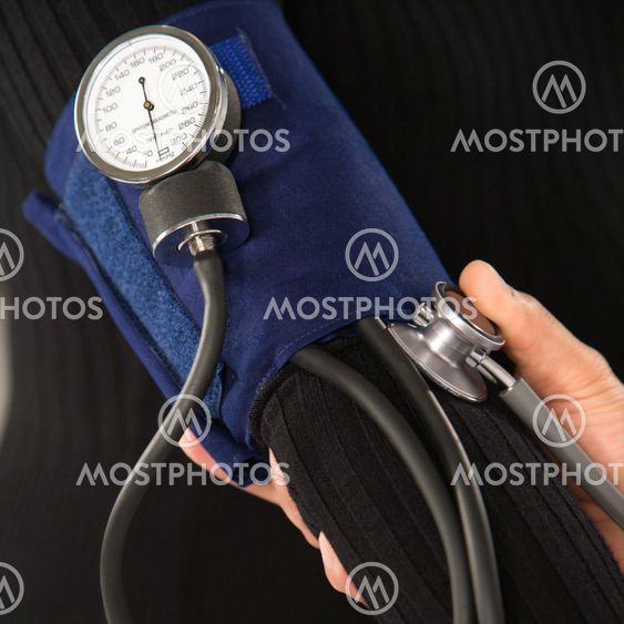 Doctor testing blood pressure.