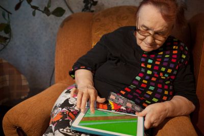 Senior woman surfing the internet on a tablet