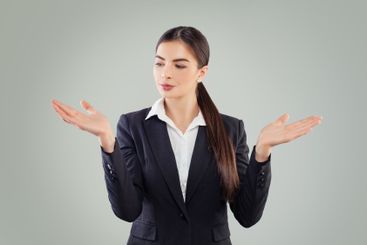 Pretty brunette business woman in black suit showing her...