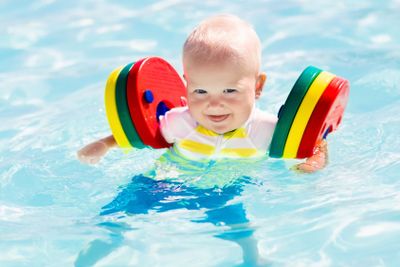 Little baby boy playing in swimming pool