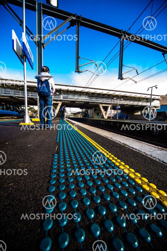 Morning at train station platform with safety dots