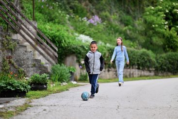 Children playing together in a park or engaging in a game.