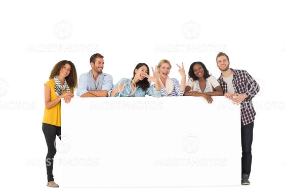 Happy group of young friends leaning on large poster