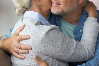 close up of married senior couple hugging
