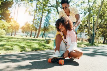 Fun, skateboarder and couple in city, smile and travel...
