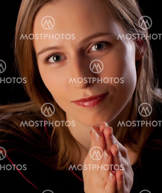 Beautiful young woman with hands folded asking for help