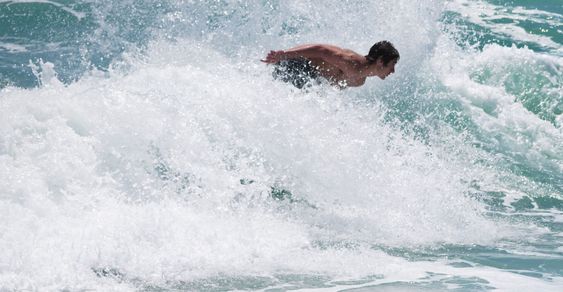 Skimboarding.