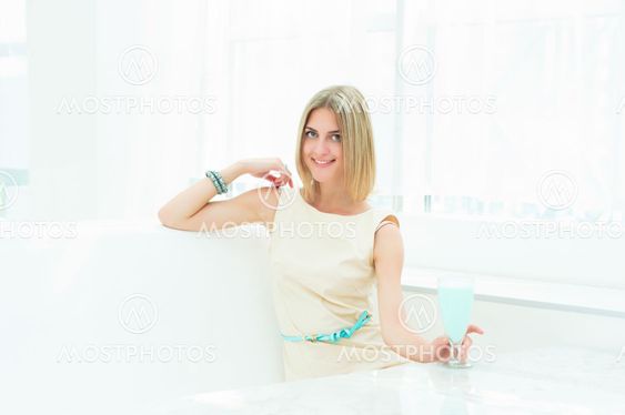 Portrait of a cute woman in a city cafe