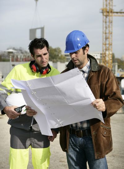 construction site supervisors looking at a blueprint