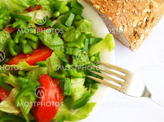Healthy vegetarian Salad and bread on the white plate