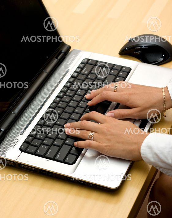 Woman working on laptop.