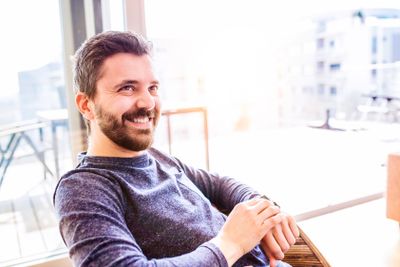 Man working from home using smart watch, living room