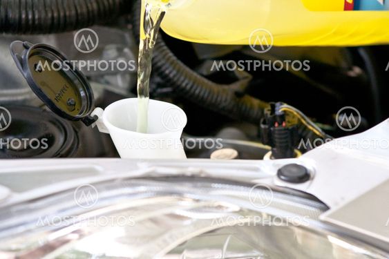 Yellow container pouring into a open mouth of another container