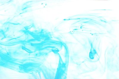 Abstract blue pigment paint color in water.