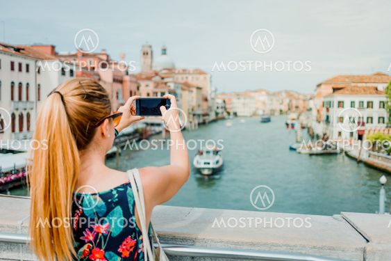 Young woman using smartphone in Venice, Italy