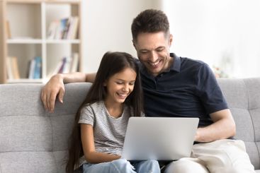 Happy single parent dad tween age daughter enjoy using...