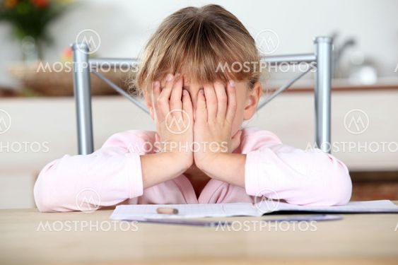 Frustrated child unable to complete her homework