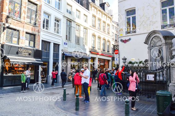 Brussels, Belgium - April 2015: Group of tourists visiting Manneken Pis or Little Man Pee, a landmark small bronze sculpture designed by Hiëronymus Duquesnoy the Elder, located near Grand Place in the city of Brussels, Belgium