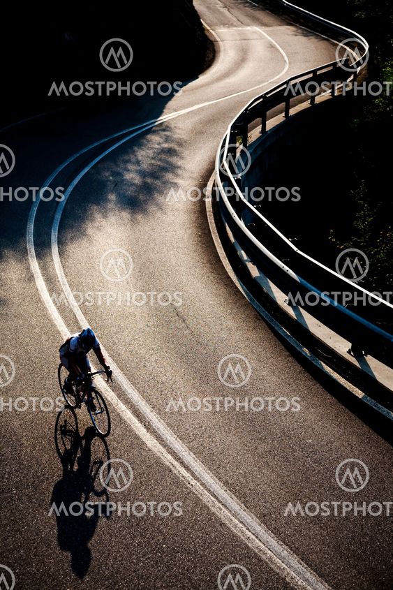 Cyclist riding along a mountain road