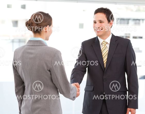Cheerful businessman and businesswoman concluding a deal