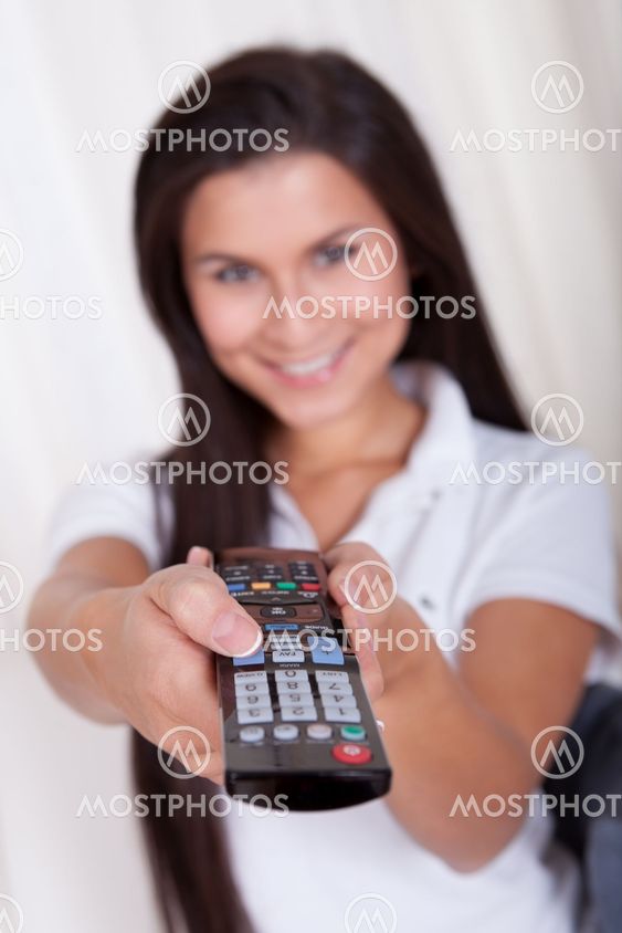 Smiling woman with a remote control