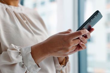 Hands, texting and phone for business woman in modern...