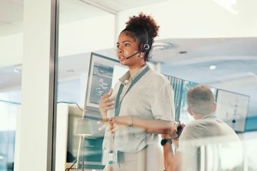 Concern, control room and headset with woman in airport...