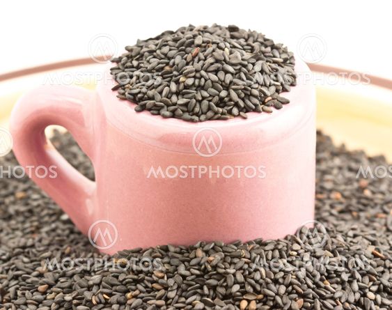 pile grain sesame in container on disk