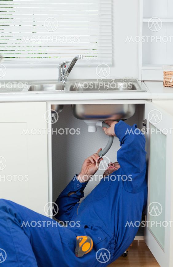 Portrait of a repairman fixing a sink