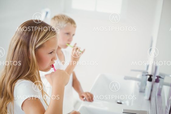 Boy and girl brushing teeth