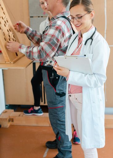 Doctor writing down results from occupational therapy...