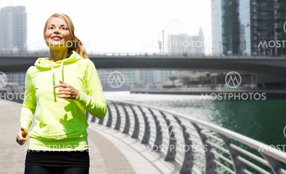 happy young woman jogging outdoors