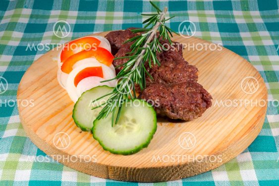 Cevapcici on a wooden dish