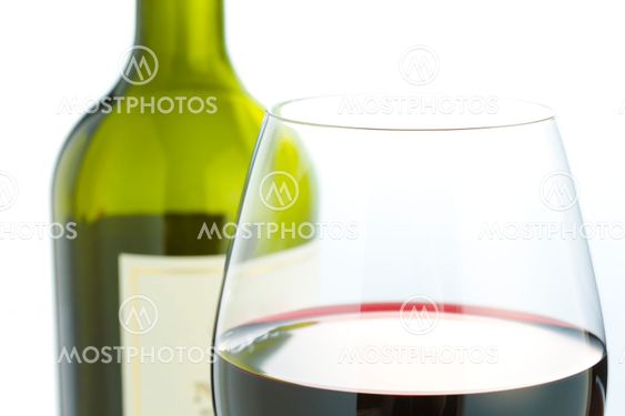 Glass and red wine bottle