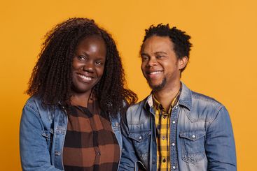 African american romantic couple smiling and posing next...