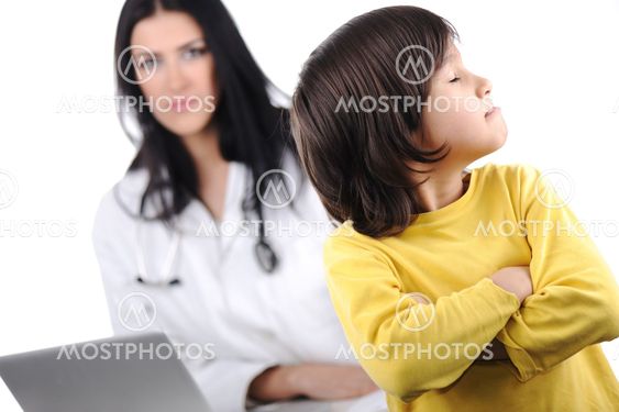 Young female doctor examining little cute angry child...