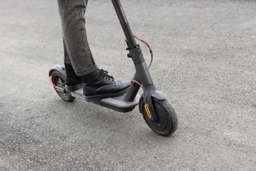 casual male riding electric scooter