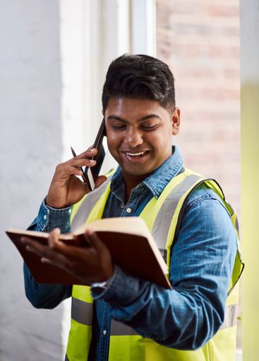Engineer, phone call and notebook for construction...