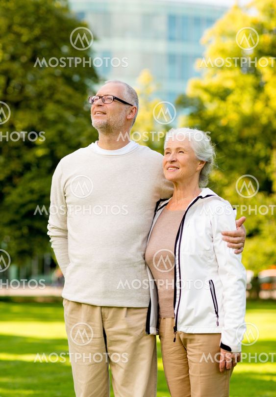 senior couple hugging in city park