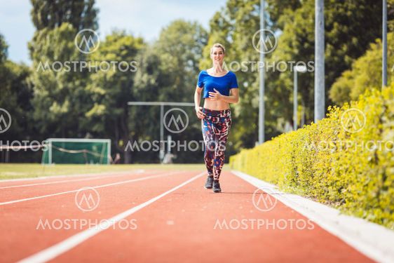 Woman jogging on the running track