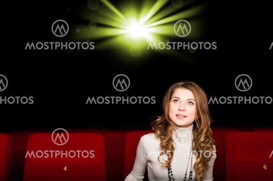 young attractive woman sitting in a cinema