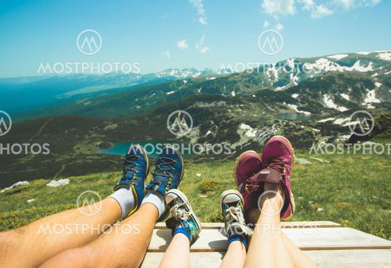 Legs of traveler family resting on a high mountain