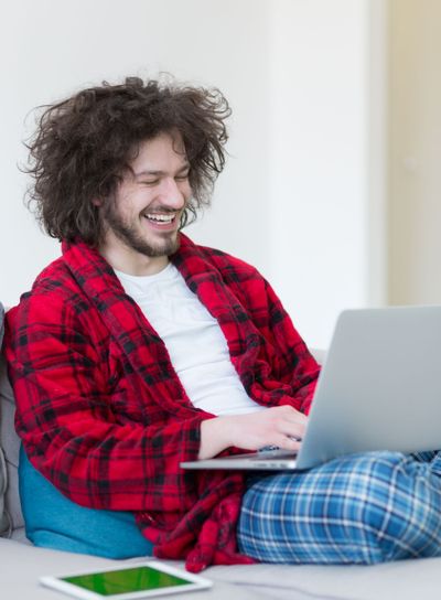 man freelancer in bathrobe working from home